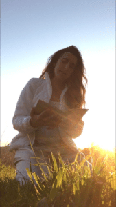 Photo of Maura with a book while backlit