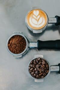 photo of coffee in different forms, beans, grounds and espresso